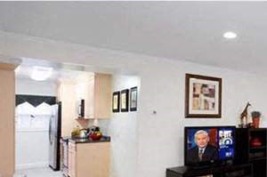 Newton Park Apartments - Living Room a living room with a table and a television